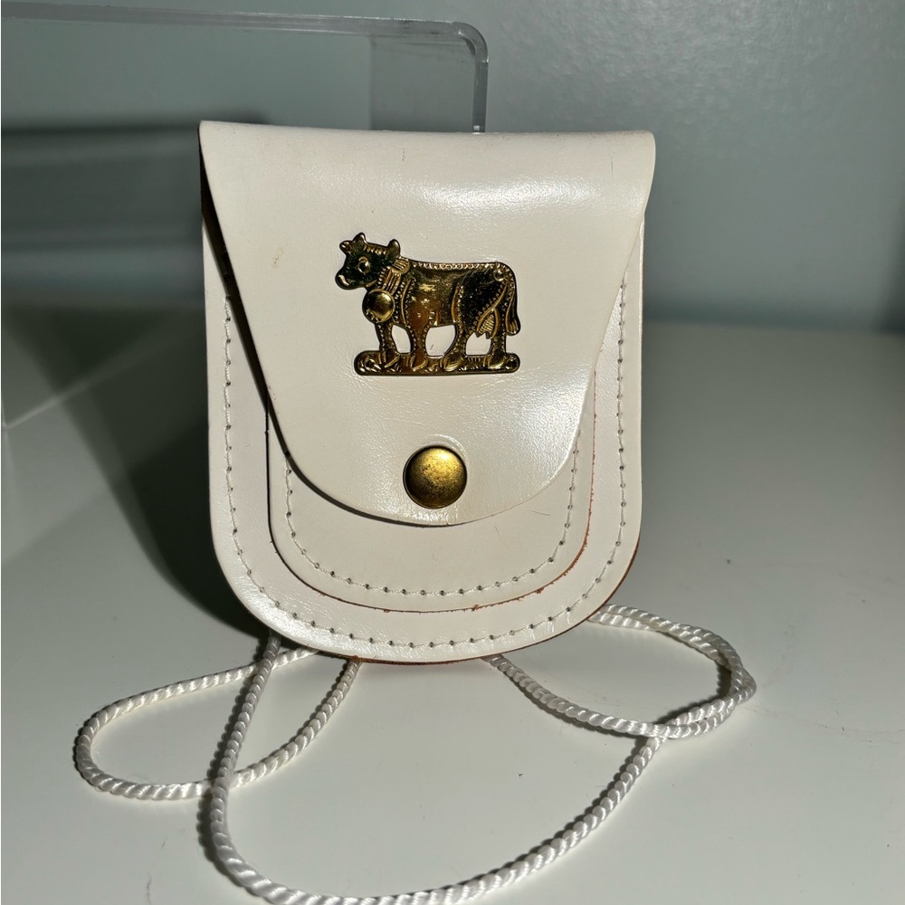 White leather pouch, mini w/metal cow accent. String as strap is replaceable